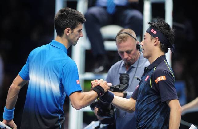 Tennis - 2015 ATP Tennis Herren World Tour Finals at The O2 - Day One Group : Stan Smith : Mens singles : Novak Djokovic (Serb) vs. Kai Nishikori (Jap) Novak Djokovic after his win over Nishikori at the net COLORSPORT ANDREW COWIE 