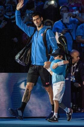 15.11.2015. The O2, London, England. ATP Tennis Herren Tennis Tour Finals. Day 1. Novak Djokovic (SRB) 1 enters the arena with his mascot for his round robin match with Kei Nishikori (JPN) 8 . Novak Djokovic won the match 6-1, 6-1. xStephenxBartholomewx  ActionPlus11681869