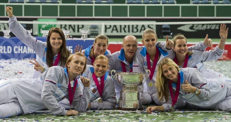 Czech Republic team players Tereza Smitkova (L-R bottom), Lucie Hradecka, Petra Kvitova, Lucie Safarova (L-R), Denisa Allertova, Petr Pala (captain), Karolina Pliskova, Barbora Strycova celebrate during the awarding ceremony for the Fed Cup tennis final match between Czech Republic and Russia in Prague, Czech Republic, November 15, 2015. Czech Republic beat Russia in tennis Fed Cup final 3-2 and defended title. (CTKxPhoto VitxSimanek) CTKPhotoP201511150768801 VIS 036