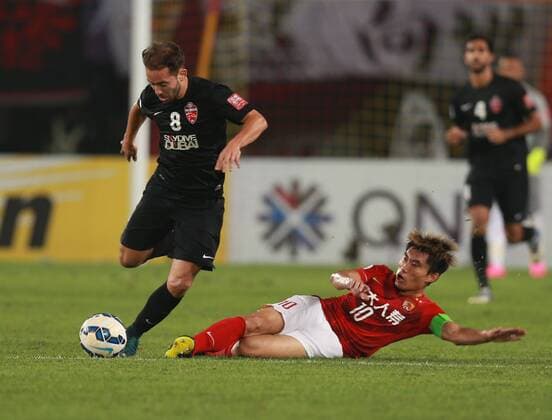 Zheng Zhi of China s Guangzhou Evergrande, bottom, slide-tackles Everton Augusto de Barros Ribeiro of UAE s Al Ahli during their second final match of the AFC Champions League 2015 in Guangzhou city, south China s Guangdong province, 21 November 2015. China s Guangzhou Evergrande defeated UAE s Al Ahli 1-0 to win the AFC Champions League 2015. Elkeson scores to lead Guangzhou Evergrande to win AFC Champions League  20151121_34136