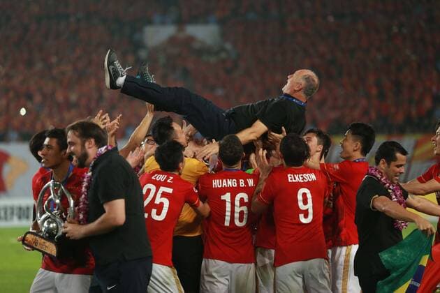 Head coach Luiz Felipe Scolari, top, is thrown up by his playes of China s Guangzhou Evergrande to celebrate at the award ceremony after they defeated UAE s Al Ahli during their second final match to win the AFC Champions League 2015 in Guangzhou city, south China s Guangdong province, 21 November 2015. Brazilian forward Elkeson scored a stunning solo effort as China s Guangzhou Evergrande edged Emiratis Al-Ahli 1-0 on Saturday (21 November 2015) to win their second Asian Champions League title in three years. Guangzhou, who won a fifth consecutive Chinese title three weeks ago, will now represent Asia at the FIFA Club World Cup in Japan next month after coach Luiz Felipe Scolari extended his unbeaten run to 23 matches since taking charge in June. Guangzhou Evergrande win second Asian Champions League title in three years  20151121_35089