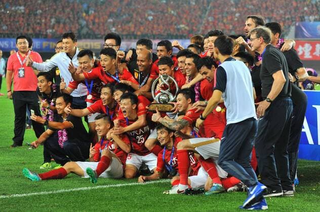 Players of China s Guangzhou Evergrande celebrate at the award ceremony after defeating UAE s Al Ahli during their second final match to win the AFC Champions League 2015 in Guangzhou city, south China s Guangdong province, 21 November 2015. Brazilian forward Elkeson scored a stunning solo effort as China s Guangzhou Evergrande edged Emiratis Al-Ahli 1-0 on Saturday (21 November 2015) to win their second Asian Champions League title in three years. Guangzhou, who won a fifth consecutive Chinese title three weeks ago, will now represent Asia at the FIFA Club World Cup in Japan next month after coach Luiz Felipe Scolari extended his unbeaten run to 23 matches since taking charge in June. Guangzhou Evergrande win second Asian Champions League title in three years  20151121_50968