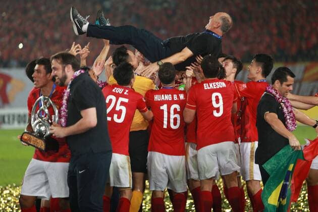 Head coach Luiz Felipe Scolari, top, is thrown up by his playes of China s Guangzhou Evergrande to celebrate at the award ceremony after they defeated UAE s Al Ahli during their second final match to win the AFC Champions League 2015 in Guangzhou city, south China s Guangdong province, 21 November 2015. Brazilian forward Elkeson scored a stunning solo effort as China s Guangzhou Evergrande edged Emiratis Al-Ahli 1-0 on Saturday (21 November 2015) to win their second Asian Champions League title in three years. Guangzhou, who won a fifth consecutive Chinese title three weeks ago, will now represent Asia at the FIFA Club World Cup in Japan next month after coach Luiz Felipe Scolari extended his unbeaten run to 23 matches since taking charge in June. Guangzhou Evergrande win second Asian Champions League title in three years  20151121_66572