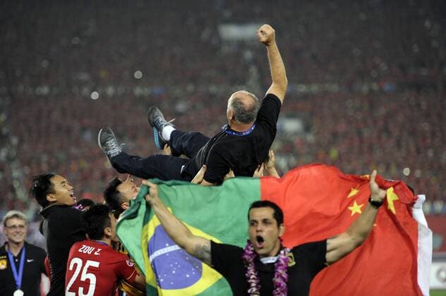 GUANGZHOU, CHINA - NOVEMBER 21: (CHINA OUT) Luiz Felipe Scolari, head coach of Guangzhou Evergrande, is thrown in the air by his players as they celebrate after winning the second leg of the AFC Champions League final match between Guangzhou Evergrande and Al Ahli at the Tianhe Sports Center on November 21, 2015 in Guangzhou, China.  CFP476177699 