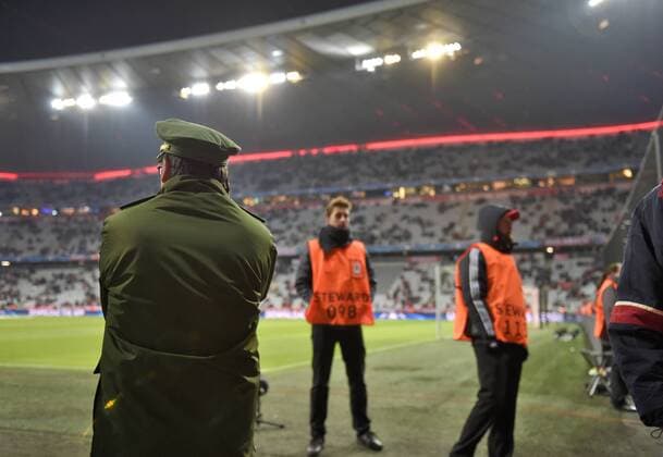 Fußball, Champions League, Sicherheitsvorkehrungen in München 24.11.2015, Fussball Championsleague 2015 2016, Vorrunde, 5.Spieltag, FC Bayern München - Olympiakos Piräus, in der Allianz-Arena München. Scharfe Sicherheitskontrollen in er Allianz-Arena nach dem Anschlag in Paris in der letzten Woche. Ein Polizist steht direkt am Spielfeldrand. 