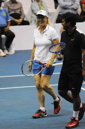 KOLKATA, INDIA - NOVEMBER 25: Czech tennis star Martina Navratilova with Indian tennis player Leander Paes in action match against Indian tennis players Sania Mirza and Mahesh Bhupathi at Kolkata Netaji Indor Stadium, on November 25, 2015 in Kolkata, India. During her visit, Navratilova will play three matches in Kolkata, Hyderabad and New Delhi, as part of International Premier Tennis League s promotional tour. (Photo by Subhankar Chakraborty Hindustan Times ) Czech Tennis Star Martina Navratilova In Kolkata