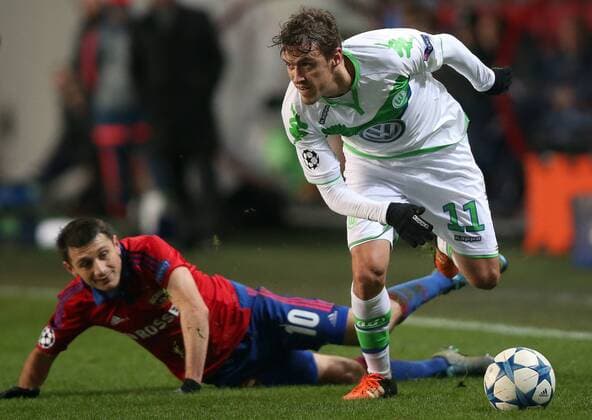 MOSCOW REGION, RUSSIA. NOVEMBER 25, 2015. CSKA s Alan Dzagoev (L) and Wolfsburg s Max Kruse fight for the ball in their 2015 16 Season UEFA Champions League Group B Round 5 football match at the Arena Khimki Stadium. FC Wolfsburg won the game 2:0. Sergei Fadeichev TASS  TS0129D1