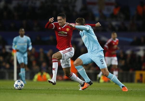 Chris Smalling of Manchester United ManU tackles Luuk de Jong of PSV Eindhoven - UEFA Champions League Group B - Manchester Utd vs PSV Eindhoven - Old Trafford Stadium - Manchester - England - 25th November 2015 - Pic Simon Bellis Sportimage EDITORIAL USE ONLY. No use with unauthorised audio, video, data, fixture lists, club league logos or live services. Online in-match use limited to 120 images, no video emulation. No use in betting, games or single club league player publications.