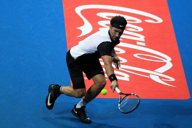 (151206) -- PASAY CITY, Dec. 6, 2015 -- Spanish player Carlos Moya of Singapore Slammers returns the ball against Russian player Marat Safin of Japan Warriors during their match in the International Premier Tennis League (IPTL) in Pasay City, the Philippines, Dec. 6, 2015. Carlos Moya won 6-4. ) (SP)PHILIPPINES-PASAY CITY-TENNIS-IPTL RouellexUmali 