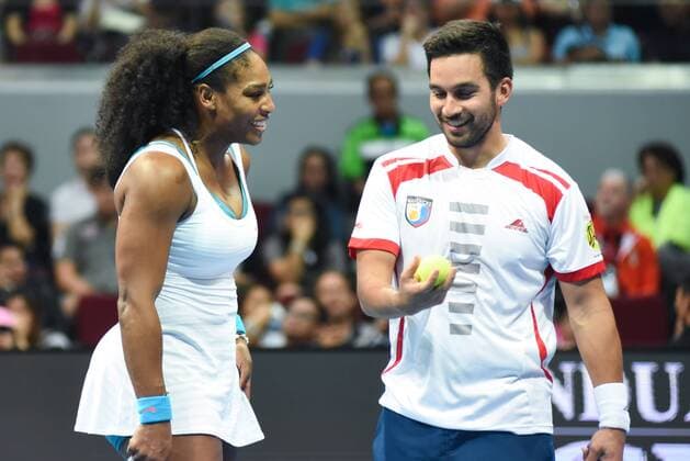Dec. 8, 2015 - Pasay City, Manila, Philippines - MANILA, Philippines - USAÃ¢â‚¬â ¢s Serena Williams and Treat Huey of the Philippine Mavericks share a light moment during their mixed doubles match for the International Premiere Tennis League (IPTL) at the Mall of Asia Arena in Pasay City, south of Manila, Philippines on December 08, 2015. International Premiere Tennis League in Manila  - ZUMAn230