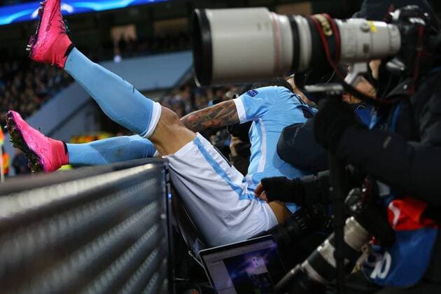 Fußball, Champions League, Manchester City - Borussia Mönchengladbach Aleksander Kolarov of Manchester City ends up amongst the photographers after falling over the advertising boards - Manchester City vs Monchengladbach - UEFA Champions League - Etihad Stadium - Manchester - 08 12 2015 Pic Philip Oldham SportImage EDITORIAL USE ONLY. No use with unauthorised audio, video, data, fixture lists, club league logos or live services. Online in-match use limited to 120 images, no video emulation. No use in betting, games or single club league player publications.