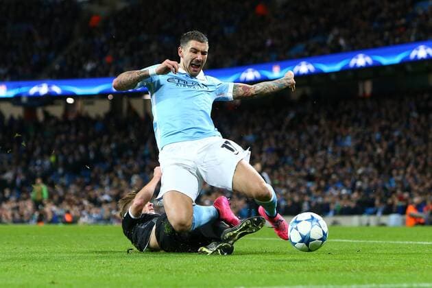 Fußball, Champions League, Manchester City - Borussia Mönchengladbach Nico Elvedi of Monchengladbach tackles Aleksander Kolarov of Manchester City - Manchester City vs Monchengladbach - UEFA Champions League - Etihad Stadium - Manchester - 08 12 2015 Pic Philip Oldham SportImage EDITORIAL USE ONLY. No use with unauthorised audio, video, data, fixture lists, club league logos or live services. Online in-match use limited to 120 images, no video emulation. No use in betting, games or single club league player publications.