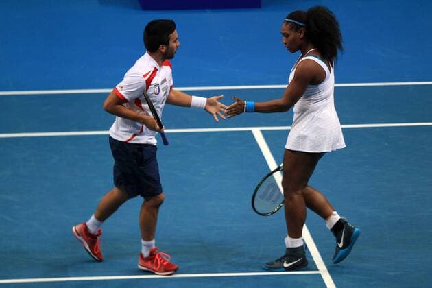 PASAY CITY, Dec. 8, 2015 -- Philippine Mavericks players Treat Huey (L) of the Philippines and Serena Williams of the United States exchange high fives during their mixed doubles match against the Micromax Indian Aces in the International Premier Tennis League (IPTL) in Pasay City, Philippines, Dec. 8, 2015. Micromax Indian Aces won 6-3. ) Authorized by ytfs (SP)PHILIPPINE-PASAY CITY-TENNIS-IPTL RouellexUmali 