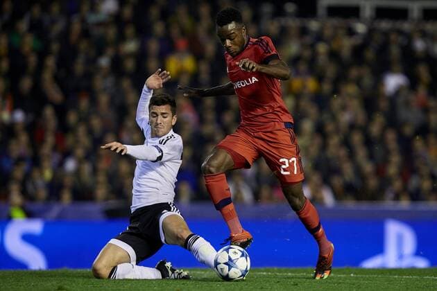 Maxwell Cornet (R) Olympique Lyonnais with the ball next to Jose Luis Gaya of Valencia CF - UEFA Champions League Group H - Valencia CF vs Olympique Lyonnais - Mestalla Stadium - Valencia- Spain - 09th December 2015 - Pic David Aliaga Sportimage EDITORIAL USE ONLY. No use with unauthorised audio, video, data, fixture lists, club league logos or live services. Online in-match use limited to 120 images, no video emulation. No use in betting, games or single club league player publications.