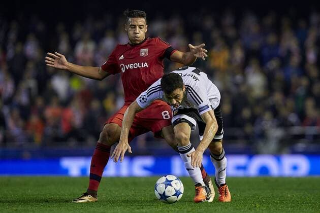 Corentin Tolisso (L) of Olympique Lyonnais competes for the ball with Javi Fuego of Valencia CF - UEFA Champions League Group H - Valencia CF vs Olympique Lyonnais - Mestalla Stadium - Valencia- Spain - 09th December 2015 - Pic David Aliaga Sportimage EDITORIAL USE ONLY. No use with unauthorised audio, video, data, fixture lists, club league logos or live services. Online in-match use limited to 120 images, no video emulation. No use in betting, games or single club league player publications.