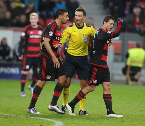 Leverkusen, Germany, 9th Dec 2015. Champions League, Bayer 04 Leverkusen vs FC Barcelona Barca Schiedsrichter Mark Clattenburg trennt Chicharito (R) und Karim Bellarabi (Leverkusen).