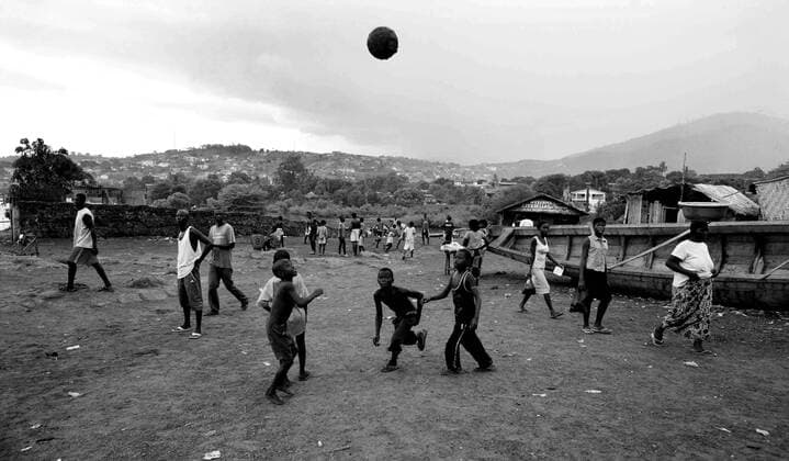 Image ©Licensed to i-Images Picture Agency. 31 05 2008. Sierra Leone, Africa. Children play football in the rain in a slum in Freetown, Sierra Leone. Picture by Sierra Leone  - ZUMA