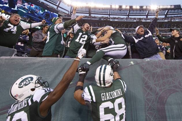 December 27, 2015 - East Rutherford, New Jersey, U.S. - New York Jets wide receiver ERIC DECKER (87) jumps into the stands after catching the overtime touchdown pass during the NFL American Football Herren USA game between the New England Patriots and the New York Jets at MetLife Stadium in East Rutherford, New Jersey. The New York Jets won 26-20. NFL 2015: Hometown Jets Squeak by Patriots 26-20 in OT - ZUMAc04_