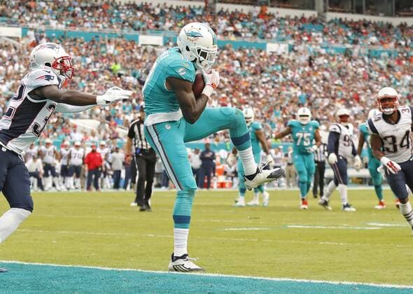 Jan. 3, 2016 - Miami Gardens, FL, USA - Miami Dolphins wide receiver DeVante Parker (11) scores as New England Patriots free safety Devin McCourty (32) fails to defend during the second quarter on Sunday, Jan. 3, 2016, at Sun Life Stadium in Miami Gardens, Fla. New England Patriots at Miami Dolphins - ZUMAm67_