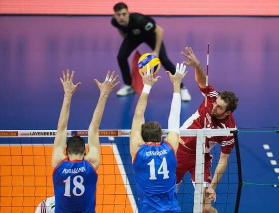 Berlin, Deutschland, 05.01.2016: Volleyball Olympia Qualifikation Männer Maenner 2016 - Spiel 3 Serbien - Polen. Mika Mateusz (Poland 20) against Marko Podrascanin (Serbia 18) and Aleksandar Atanasijevic (Serbia 14)