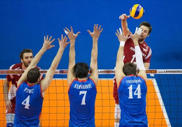 Berlin, Deutschland, 05.01.2016: Volleyball Olympia Qualifikation Männer Maenner 2016 - Spiel 3 Serbien - Polen. Michal Kubiak (Poland 13) against Nemanja Petric (Serbia 4), Dragan Stankovic (Serbia 7), Aleksandar Atanasijevic (Serbia 14)