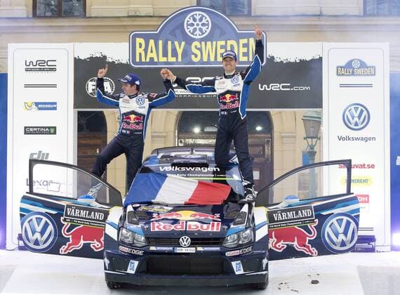 Motorsport, WRC, Rallye Schweden, Siegerehrung 160214 Sebastien Ogier med kartläsare Julien Ingrassia, Volkswagen Motorsport, Volkswagen Polo WRC Motorsport Rallye WM jublar efter segern vid prisutdelningen under Rally Sweden den 14 februari 2016 i Karlstad.  Copyright: ANNA-LENAxBERGQVIST BB160214BB858