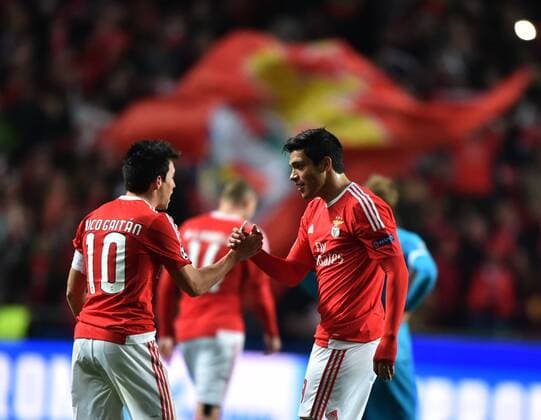 Benfica s Nicolas Gaitan (L) and Raul Jimenez celebrate for teammate Jonas goal during the first leg of round 16 at the UEFA Champions League soccer match between SL Benfica vs FC Zenit at the Luz stadium in Lisbon, Portugal, on Feb. 16, 2016. Benfica won 1-0. ) (SP)PORTUGAL-LISBON-SOCCER-UEFA CHAMPIONS LEAGUE-BENFICA VS ZENIT ZhangxLiyun 