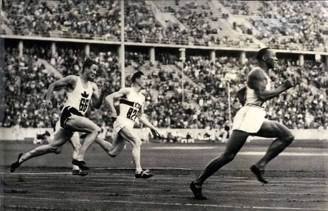 1936 - Berlin Olympics: Jesse Owens beating the 200 meter record in 20.7 seconds (time according to Associated Press Almanac) Track And Field ----- Decathlon Javelin Marathons Running Shotput Sprinting - ZUMAk09_