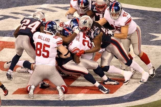 Feb. 5, 2012 - Indianapolis, IN, USA - New York Giants running back Brandon Jacobs 27 gets gang tackled during Super Bowl XLVI. Super Bowl XLVI came down to the final seconds as the New York Giants beat the New England Patriots with a final score of 21-17 in Lucas Oil Stadium in Indianapolis, IN. Photo By Aaron Suozzi Super Bowl XLVI New York Giants vs. New England Patriots - ZUMAs102