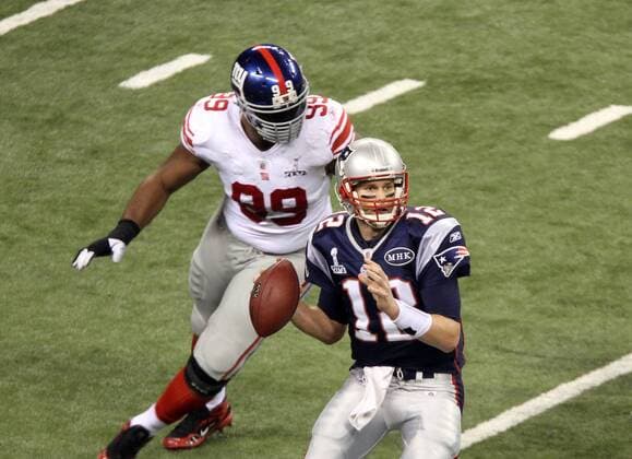 Feb. 5, 2012 - Indianapolis, IN, USA - New England Patriots defensive tackle Mike Wright 99 puts pressure on New England Patriots quarterback Tom Brady 12 during Super Bowl XLVI. Super Bowl XLVI came down to the final seconds as the New York Giants beat the New England Patriots with a final score of 21-17 in Lucas Oil Stadium in Indianapolis, IN. Photo By Aaron Suozzi Super Bowl XLVI New York Giants vs. New England Patriots - ZUMAs102