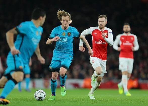 FuÃŸball, Champions League, FC Arsenal - FC Barcelona 23.02.2016. Emirates Stadium, London, England. UEFA Champions League. Arsenal versus Barcelona. Barcelona Midfielder Ivan Rakitic brings the ball forward as Barcelona Forward Luis Suarez looks for the pass xMarkxKertonx  ActionPlus11710357