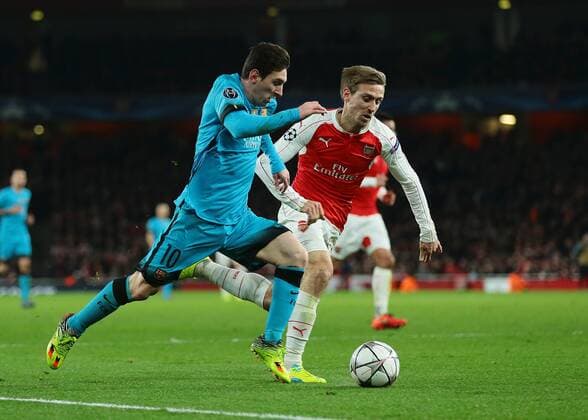 23.02.2016. Emirates Stadium, London, England. UEFA Champions League. Arsenal versus Barcelona. Barcelona Midfielder Lionel Messi feels pressure from Arsenal Defender Nacho Monreal as he makes his way into the Arsenal area xMarkxKertonx  ActionPlus11710401