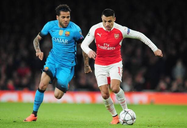 Football - 2015 2016 Champions League - Round of 16, First Leg: Arsenal vs. Barcelona Alexis Sanchez of Arsenal and Dani Alves of Barcelona at The Emirates. COLORSPORT ANDREW COWIE 
