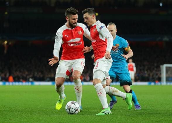 23.02.2016. Emirates Stadium, London, England. UEFA Champions League. Arsenal versus Barcelona. Arsenal Forward Olivier Giroud and Arsenal Midfielder Mesut Ã–ZIL collide during an attack on the Barcelona defence xMarkxKertonx  ActionPlus11710458