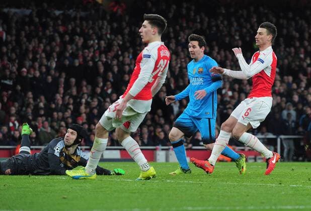 Football - 2015 2016 Champions League - Round of 16, First Leg: Arsenal vs. Barcelona Lionel Messi of Barcelona scores goal no 1 past Petr Cech at The Emirates. COLORSPORT ANDREW COWIE 