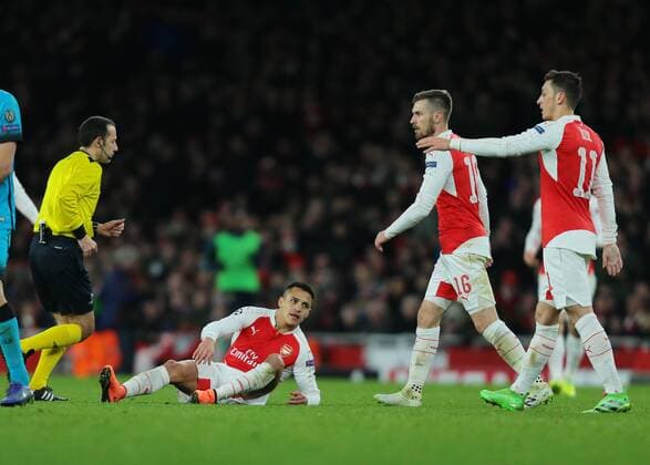23.02.2016. Emirates Stadium, London, England. UEFA Champions League. Arsenal versus Barcelona. Arsenal Forward Alexis S& xe1;nchez picks himself up off the floor after being fouled by Barcelona Midfielder Sergio Busquets xMarkxKertonx  ActionPlus11710490