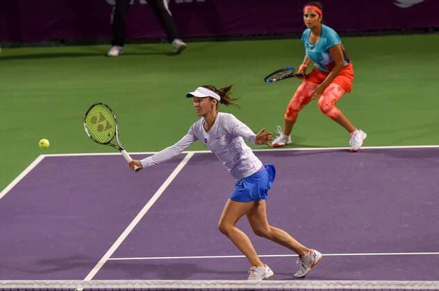 Martina Hingis (Front) of Switzerland and Sania Mirza of India compete during their women s doubles second round match against Zheng Saisai and Xu Yifan of China at the WTA Tennis Damen Qatar Open 2016 in Doha, Qatar, Feb. 23, 2016. Martina Hingis and Sania Mirza won 2-1. ) (SP)QATAR-DOHA-TENNIS-QATAR OPEN 2016-WOMEN S DOUBLES Nikku 