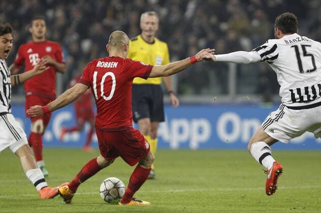 Feb. 23, 2016 - Turin, Italy - BayernÃ s Arjen Robben, left, kicks to score as he is challenged by JuventusÃ Andrea Barzagli during the Champions League first leg round of 16 football match between Juventus and Bayern at the Juventus Stadium. The game ended 2-2. Italy Football Champions League: Round of 16 First Leg - Juventus vs Bayern - ZUMAp133