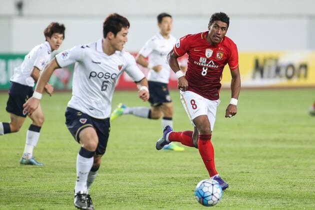 GUANGZHOU, CHINA - FEBRUARY 24: (CHINA OUT) Paulinho 8 of Guangzhou Evergrande and Kim Jun-su 6 of Pohang Steelers compete for the ball during the AFC Champions League Group H match between Guangzhou Evergrande and Pohang Steelers at Tianhe Center on February 24, 2016 in Guangzhou, China.  CFP480110909 