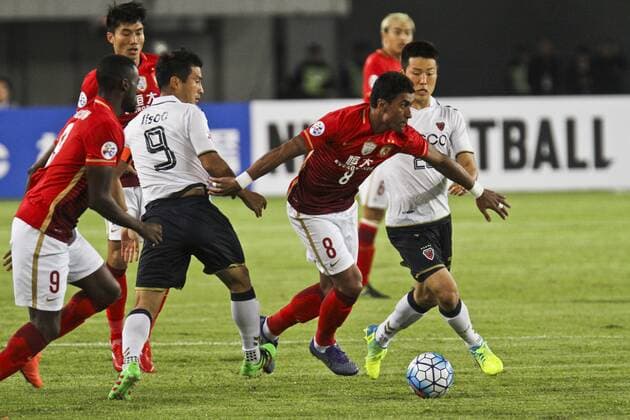 GUANGZHOU, CHINA - FEBRUARY 24: (CHINA OUT) Paulinho 8 of Guangzhou Evergrande and Hwang Ji-soo 9 of Pohang Steelers compete for the ball during the AFC Champions League Group H match between Guangzhou Evergrande and Pohang Steelers at Tianhe Center on February 24, 2016 in Guangzhou, China.  CFP480110921 