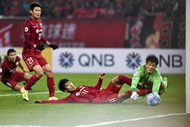 SHANGHAI, CHINA - MARCH 02: (CHINA OUT) Lu Wenjun 11 of Shanghai SIPG and goalkeeper No Dong-geon 1 of Suwon Samsung Bluewings compete for the ball during the AFC Champions League Group G match between Shanghai SIPG and Suwon Samsung Bluewings at Shanghai Stadium on March 2, 2016 in Shanghai, China.  CFP480514635 