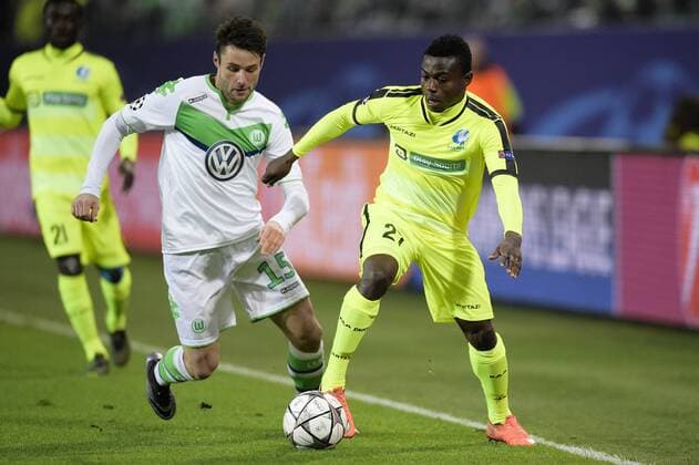 Wolfsburg s Christian Trasch and Gent s Moses Simon fight for the ball during a soccer game between German team VfL Wolfsburg and Belgian club KAA Gent, the return game of the 1 8 final s of the UEFA Champions League competition, Tuesday 08 March 2016 in Wolfsburg, Germany. Wolfsburg won the first leg 2-3. YORICKxJANSENS  x04807146x