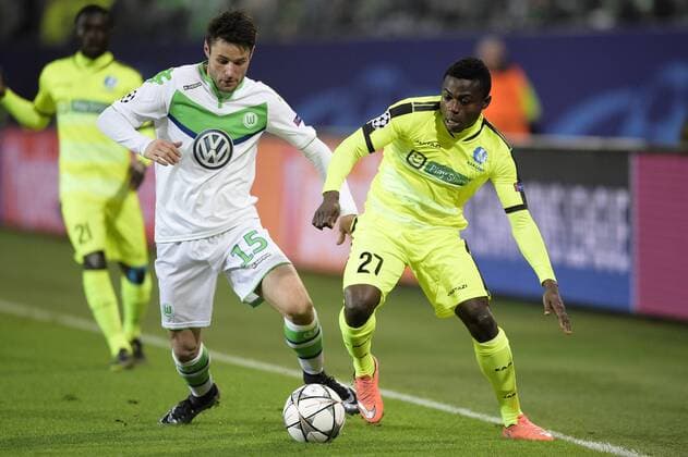 Wolfsburg s Christian Trasch and Gent s Moses Simon fight for the ball during a soccer game between German team VfL Wolfsburg and Belgian club KAA Gent, the return game of the 1 8 final s of the UEFA Champions League competition, Tuesday 08 March 2016 in Wolfsburg, Germany. Wolfsburg won the first leg 2-3. YORICKxJANSENS  x04807145x