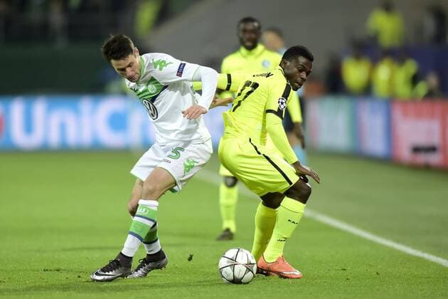Simon Moses Daddy Ajala forward of KAA Gent in action with Christian Trasch midfielder of VfL Wolfsburgduring the Champions League Round of 16, second leg match between VfL Wolfsburg and KAA Gent at the Volkswagen Arena in Wolfsburg, Germany. FOOTBALL : Wolfsbourg vs La gantoise - Ligue des Champions - 08 03 2016 PHOTONEWS PANORAMIC 