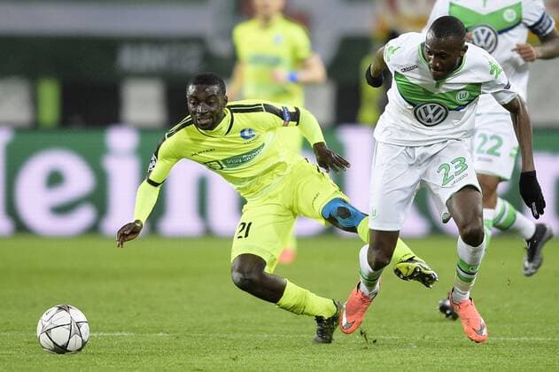 Gent s Nana Asare and Wolfsburg s Josuha Guilavogui fight for the ball during a soccer game between German team VfL Wolfsburg and Belgian club KAA Gent, the return game of the 1 8 final s of the UEFA Champions League competition, Tuesday 08 March 2016 in Wolfsburg, Germany. Wolfsburg won the first leg 2-3. YORICKxJANSENS  x04807162x