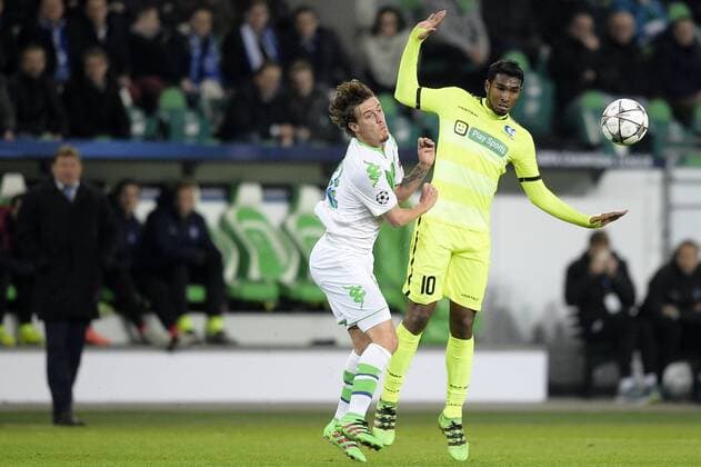 Wolfsburg s Max Kruse and Gent s Renato Neto fight for the ball during a soccer game between German team VfL Wolfsburg and Belgian club KAA Gent, the return game of the 1 8 final s of the UEFA Champions League competition, Tuesday 08 March 2016 in Wolfsburg, Germany. Wolfsburg won the first leg 2-3. YORICKxJANSENS  x04807158x
