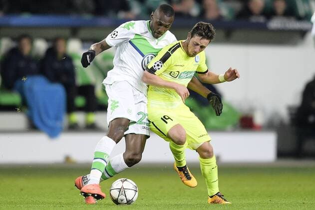 Wolfsburg s Josuha Guilavogui and Gent s Brecht Dejaegere fight for the ball during a soccer game between German team VfL Wolfsburg and Belgian club KAA Gent, the return game of the 1 8 final s of the UEFA Champions League competition, Tuesday 08 March 2016 in Wolfsburg, Germany. Wolfsburg won the first leg 2-3. YORICKxJANSENS  x04807354x