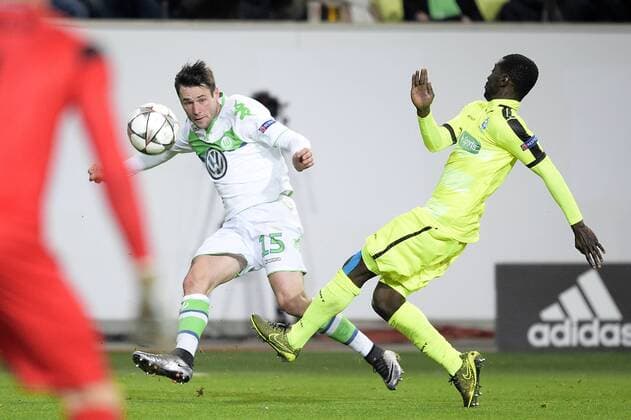 Wolfsburg s Christian Trasch and Gent s Nana Asare fight for the ball during a soccer game between German team VfL Wolfsburg and Belgian club KAA Gent, the return game of the 1 8 final s of the UEFA Champions League competition, Tuesday 08 March 2016 in Wolfsburg, Germany. Wolfsburg won the first leg 2-3. YORICKxJANSENS  x04807350x