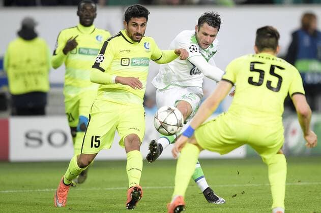 Gent s Kenneth Saief and Wolfsburg s Christian Trasch fight for the ball during a soccer game between German team VfL Wolfsburg and Belgian club KAA Gent, the return game of the 1 8 final s of the UEFA Champions League competition, Tuesday 08 March 2016 in Wolfsburg, Germany. Wolfsburg won the first leg 2-3. YORICKxJANSENS  x04807383x