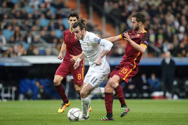 08 03.2016 UEFA Champions League Estadio Santiago Bernabeu Real Madrid CF v AS Roma Gareth Bale of Real Madrid (centre in white kit number 11) gets the better of Miralem Panic of AS Roma (right) during the UEFA Champions League last 16 second leg match in Madrid between Real Madrid and Roma at the Estadio Santiago Bernabeu in Madrid, Spain. UEFA Champions League - Real Madrid v Roma UCL_RM_Rma